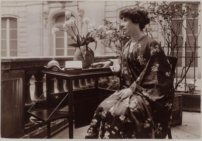 Marcelle Tinayre Sitting, a Book on a Table in Front of Her by Dornac